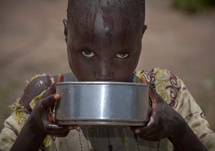 A girl drinks water in an emergency feeding program for malnourished children at the Loreto School in Rumbek, South Sudan. The school, run by the Institute for the Blessed Virgin Mary--the Loreto Sisters--of Ireland, has opened its compound to hundreds of nearby villagers facing hunger because of ongoing conflict and climate change.
